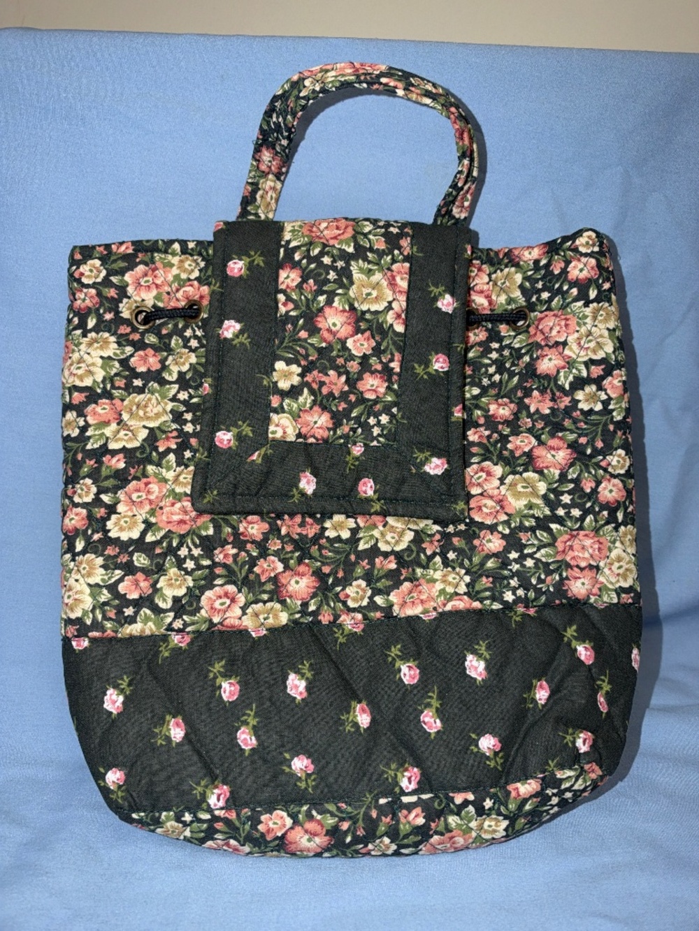 Quilted backpack.  Cinch elastic closure with magnetic flap.
